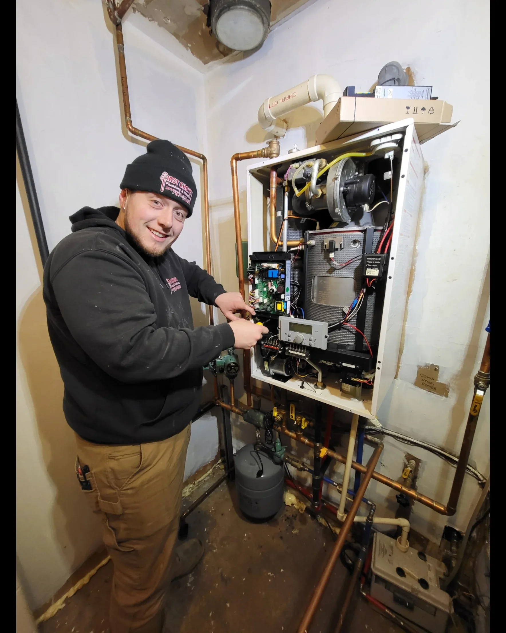 Boiler unit with copper piping, circuit controls, expansion tank, and heating system components installed
