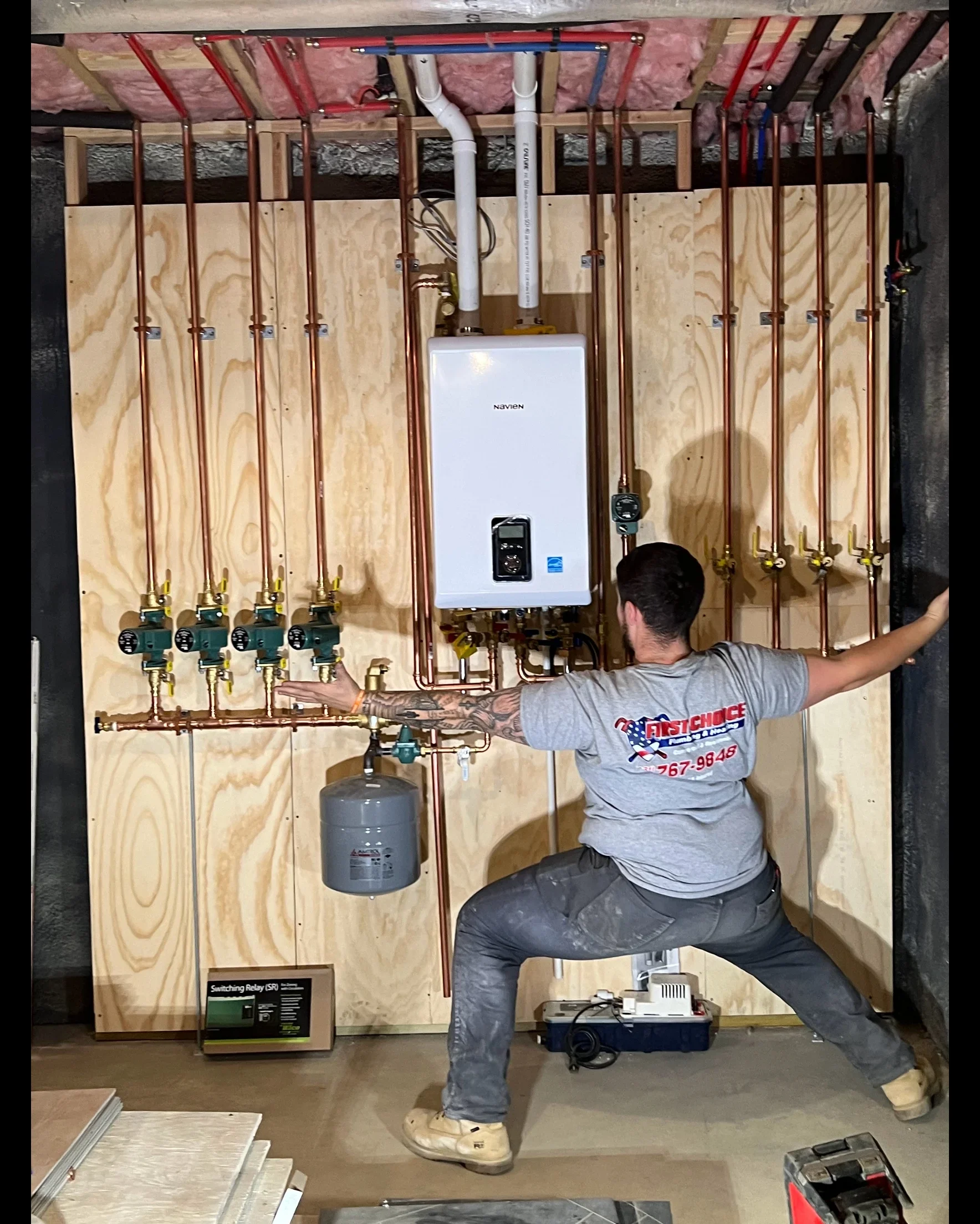 Tankless water heater with four-zone radiant heating manifolds, copper piping, and expansion tank installation