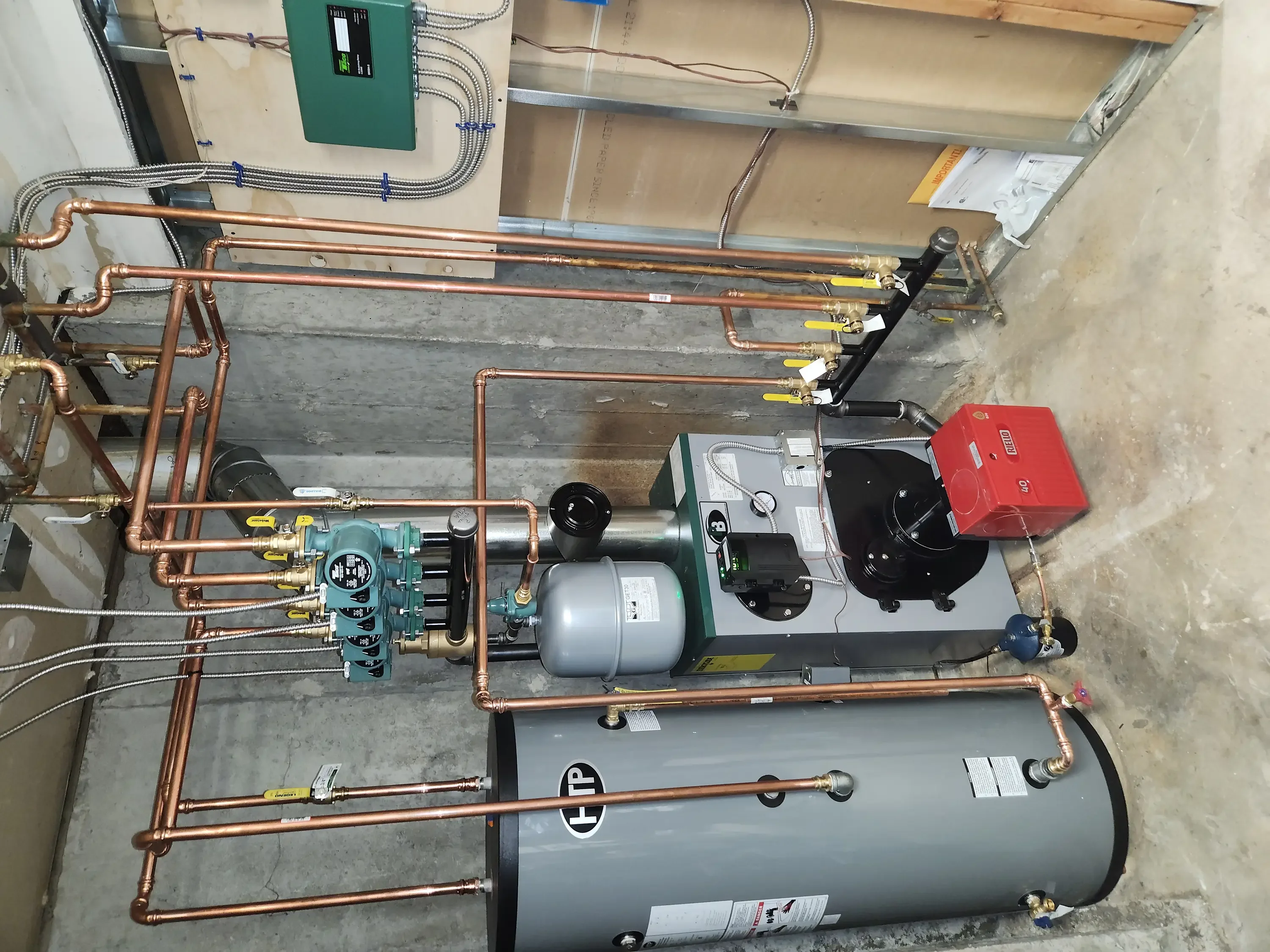Copper radiant heating piping with expansion tank, circulation pump, and multi-zone manifold control system